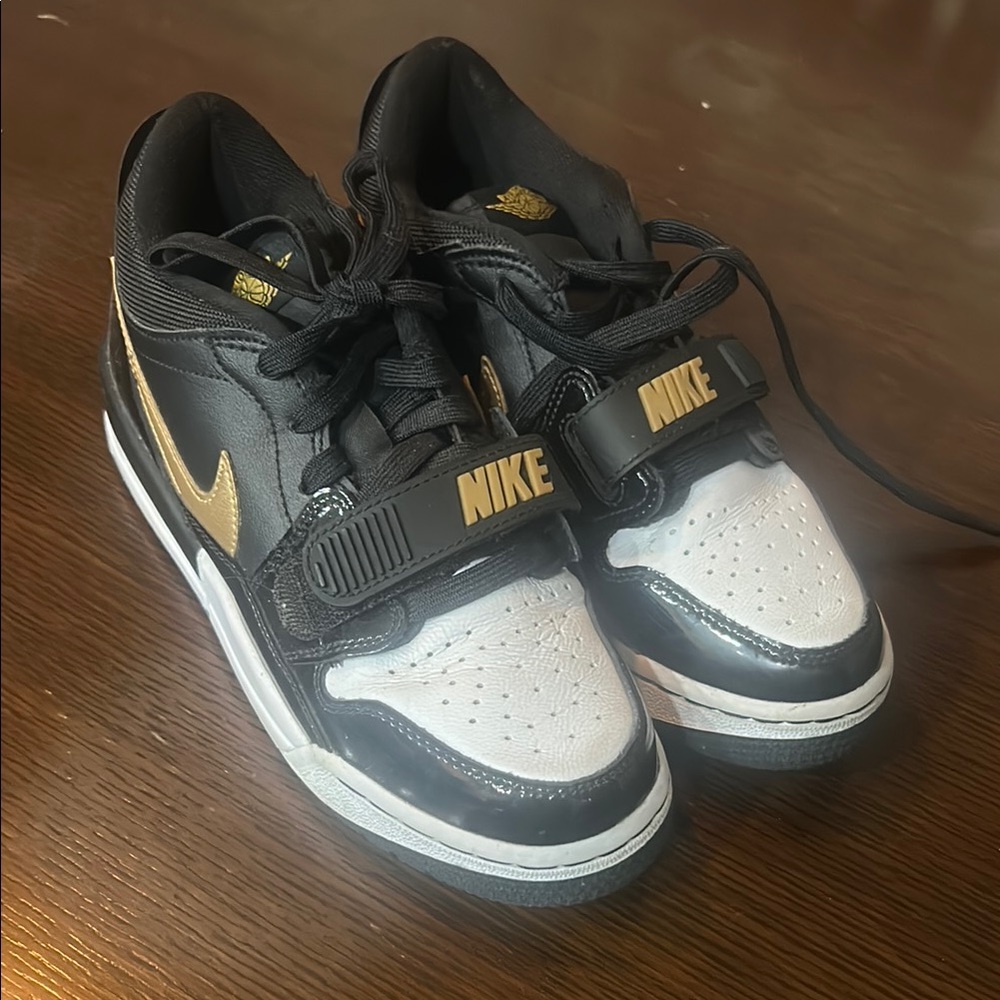 Nike Kids Black, White, and Gold Sneakers